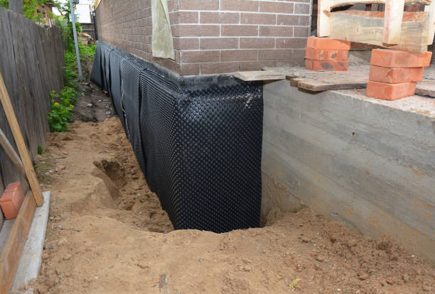 Happy homeowners after waterproofing job in Norman